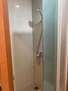 a bathroom with a shower with a glass door at Casapedian 010 Vasaka Reiz Condo 1 BR in Medan +3 photos