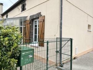 a building with a gate in front of a house at Appartement 29A - MAILLY LE CAMP in Mailly-le-Camp