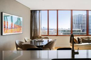a living room with a table and chairs and a couch at Forbes Manaa Living in Perth