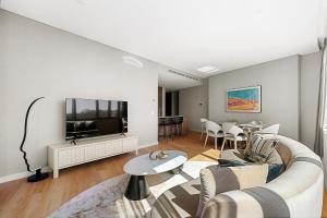 a living room with a couch and a tv at Forbes Manaa Living in Perth