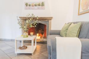 a living room with a couch and a fireplace at Up On the Roof by Rent All Como in Como