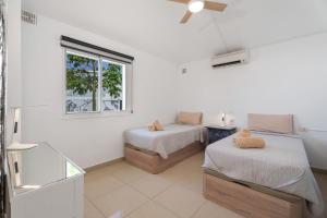 a white room with two beds and a window at Casa Zara in San Miguel de Abona +24 photos