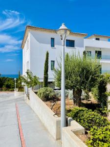 a street light in front of a white building at Coral Bay Garden in Peyia