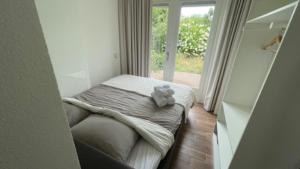 a small bedroom with a bed with a teddy bear on it at Bed & Breakfast Inn Drenthe in Fluitenberg