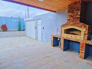 a large patio with a brick fireplace in a house at Mardakan Villa in Baku