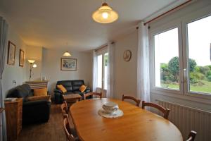 a living room with a wooden table and a couch at Le magnolia in Couzeix
