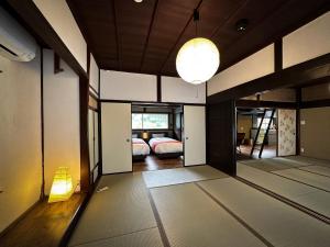 a room with two beds and a room with a lamp at NIPPONIA MIYAMA TSURUGAOKA Mountain Village in Ōno +70 photos