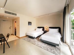 Ein Bett oder Betten in einem Zimmer der Unterkunft The StandardX, Bangkok Phra Arthit