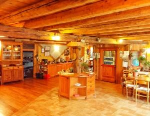 a large kitchen with wooden cabinets and a table at Agriturismo Casa Essenia in Condino