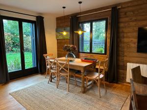 a dining room with a wooden table and chairs at Chalet de l'Ailly in Varengeville-sur-Mer