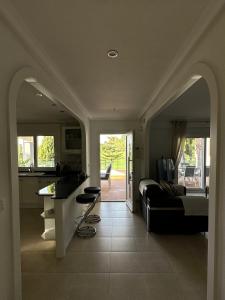a kitchen and living room with a bed and a couch at The Santander Villa in Orihuela Costa