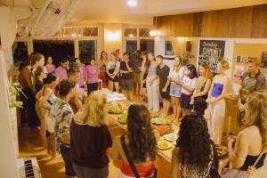 a group of people standing in a room with food at Blue Chitta Yoga & Freediving in Koh Tao