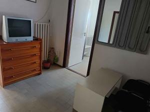 a living room with a tv on a dresser and a mirror at Holiday home Balatonbereny - Balaton 18030 in Balatonberény