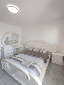 a white room with two beds and a mirror at Apartments by the beach 60-6 in Qiryat H̱ayyim