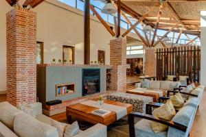a living room with couches and a fireplace at Grootbos Private Nature Reserve in Gansbaai