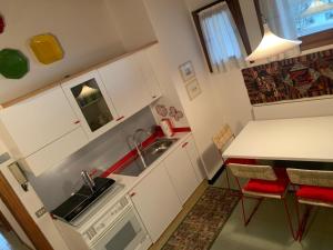 a small kitchen with a sink and a table at Mezzodi in Mareson +20 photos