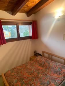 a bedroom with a bed and two windows at Mezzodi in Mareson