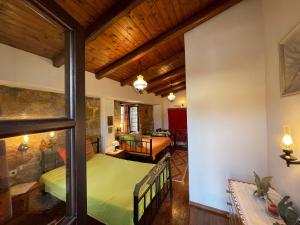 a bedroom with a green bed and a living room at Leandros Village House in Smárion