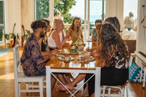 a group of people sitting at a table eating food at Blue Chitta Yoga & Freediving in Koh Tao