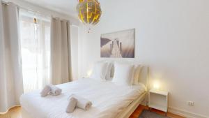 Postel nebo postele na pokoji v ubytování La Symphonie de l'Orangerie