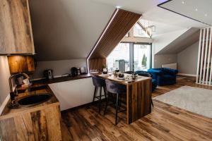 a kitchen with a island in the middle of a room at Hotel Casa Blanca in Tulgheş