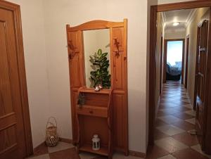 a hallway with a wooden dresser and a mirror at Casa Delfin in Punta Umbría +8 photos