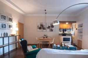 a room with a bed and a table and chairs at Casa Sant Angelo in Sarteano
