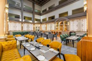 a restaurant with tables and chairs in a room at Sterling City Centre, Bokaro in Bokāro