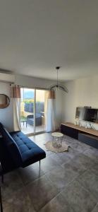 BorgoCharmant appartement的客厅里有一张蓝色的沙发和一张桌子