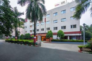a building with a palm tree in front of it at Sterling City Centre, Bokaro in Bokāro