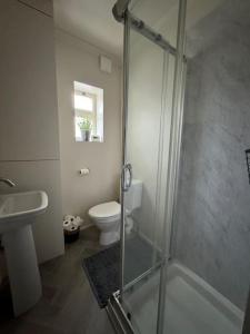 a bathroom with a shower and a toilet and a sink at Townhouse in Weymouth, Dorset in Melcombe Regis +9 photos