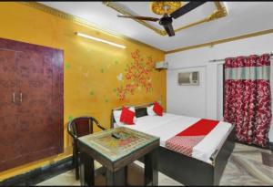 a bedroom with a bed and a table in it at Best hotel in Lucknow