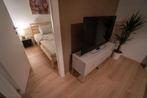 a living room with a flat screen tv and a bed at Zen na dan, Belgrade in Belgrade