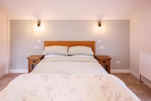 a bedroom with a large bed with two night stands at The Hayloft in Wem
