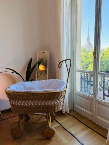a basket sitting in a room with a window at Liberty House in Turin +37 photos