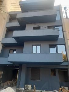 a building with a blue facade at Mp luxury houses Α3 in Larisa