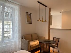 a living room with a couch and a table at La Belle Odet' - choix d'appartements- Centre ville-quais in Quimper +40 photos