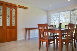 a dining room with a wooden table and chairs at Sunrise lake house in Rocky Point +17 photos