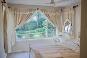 a bedroom with a bed and a large window at Sunrise lake house in Rocky Point