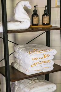 a towel rack with towels and bottles on it at ZenCabin - Luxe en Wellness in de natuur in Hulshout +79 photos