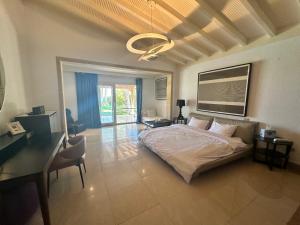 a bedroom with a bed and a desk and a desk at Serenity Villa in Sharm El Sheikh +24 photos