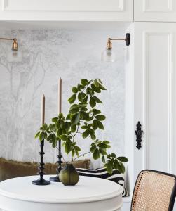 a table with two candles and a plant on it at Exclusive Darling Apt Harbour View Balcony in Sydney