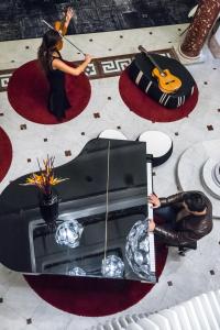 a table withumedumed figurines of a woman playing a guitar at Hotel C2 in Marseille