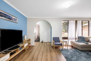 a living room with a large flat screen tv at Erowal Bay Retreat Alfresco Dining Serenity in Worrowing Heights