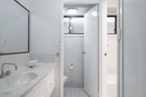 a white bathroom with a sink and a shower at Erowal Bay Retreat Alfresco Dining Serenity in Worrowing Heights +29 photos