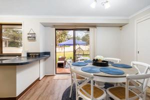 a kitchen and dining room with a table and chairs at Erowal Bay Retreat Alfresco Dining Serenity in Worrowing Heights