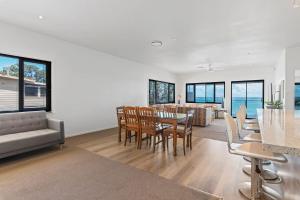 a dining room and living room with a table and chairs at Breath taking Bay Views Private Pad Spacious in Morisset East