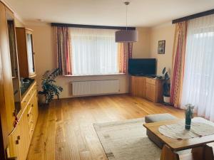 a living room with a table and a television at Haus LINDE Görtschitztal in Sankt Veit an der Glan