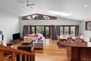 a living room with a couch and a table at Mountain Home Leura Perfect Weekend Escape in Leura