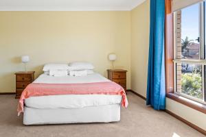 a bedroom with a bed and a large window at Coastal Delight In Shellcove in Dunmore